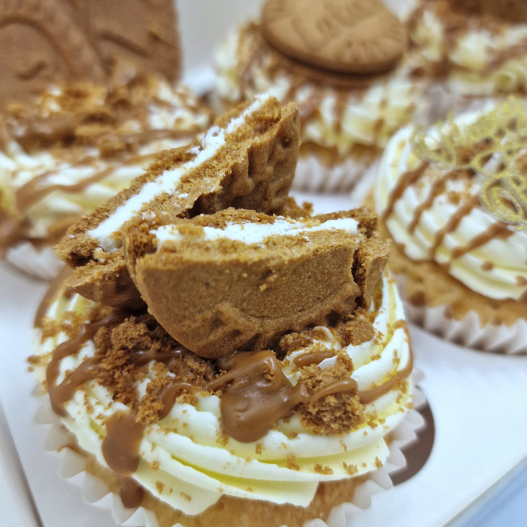 Close-up of biscoff cupcakes, featuring fluffy cupcakes topped with creamy buttercream, a drizzle of biscoff spread, and a lotus biscoff cookie garnish.